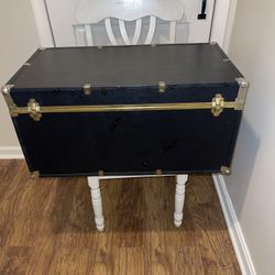 BLACK SEWARD TRUNK ON WHEELS. GOOD AS COFFEE TABLE AND GOOD FOR STORAGE 
