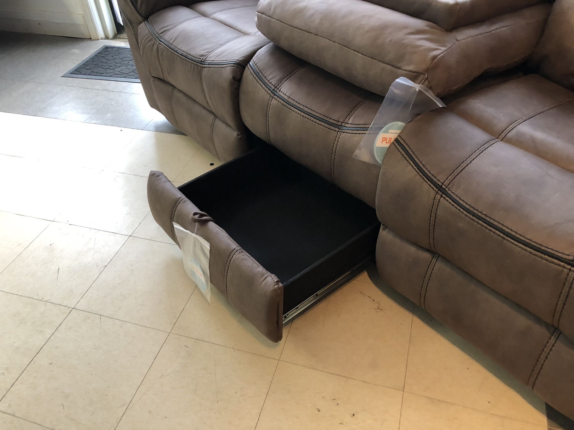 WATER RESISTANT Microfiber smooth bomber jacket material recliner. Pull out table with cup holders. Built in USB ports and wall plug ins. Hidden draw