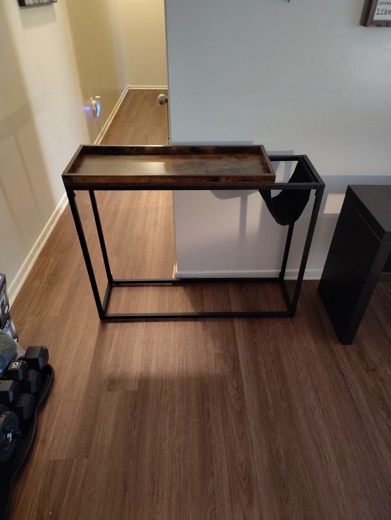 This Is a great deal. A side table to put anywhere in any room. It has a side fabric holder for books, tablets  or anything else.