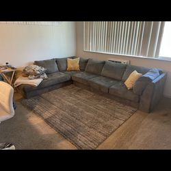 Two pieced L shape grey suede couch
