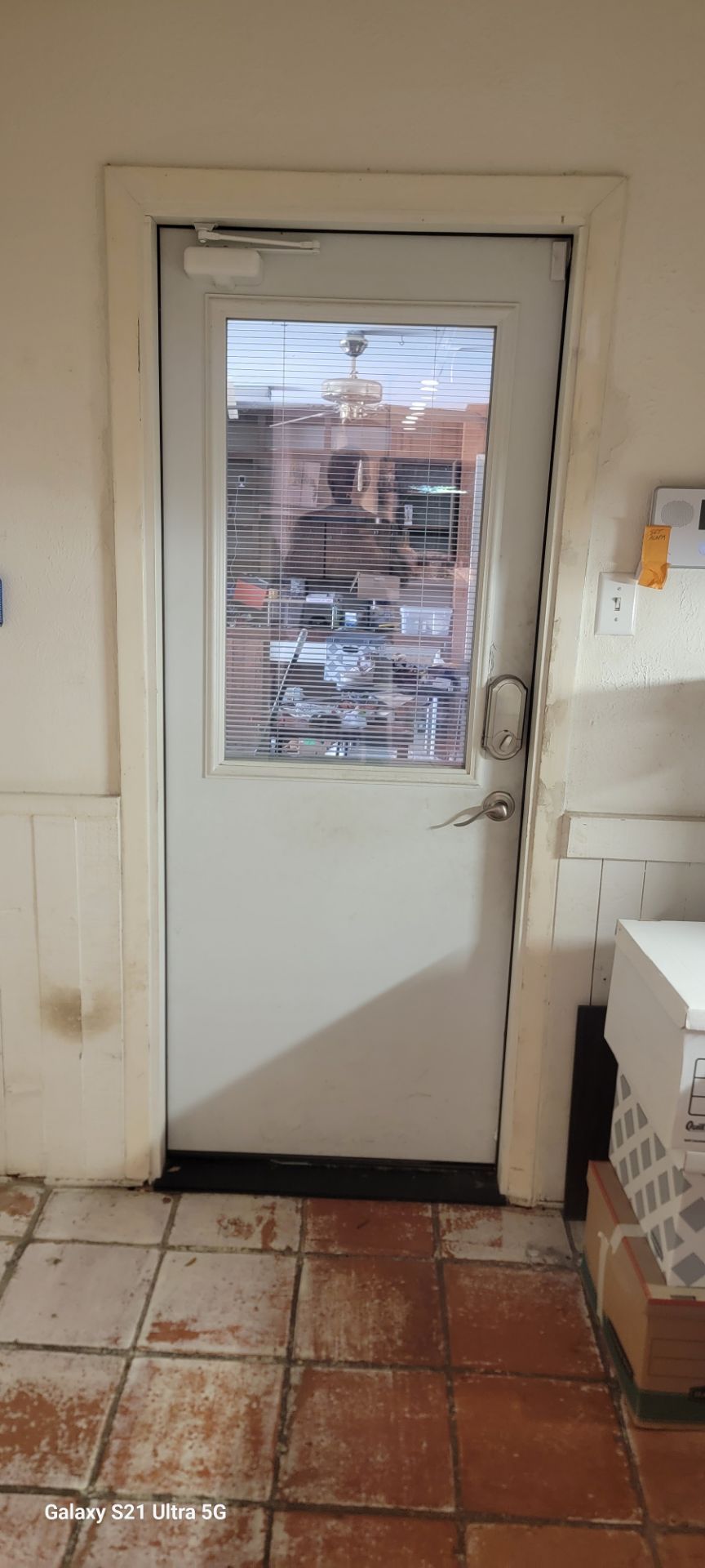 Back door to garage with blinds