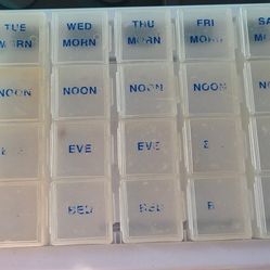 4 Times a day x 7 days a week pill organizer case. Squares approx 1" ea. Each day removable. Faded.  East, west, north