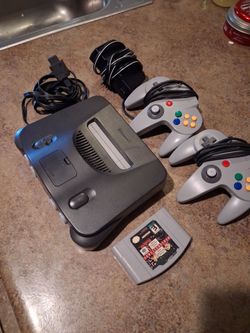 Nintendo 64 system will all hookups and two controllers in one game fully tested very good condition system is like brand new