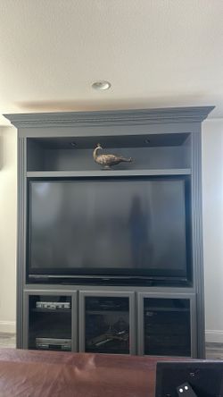 Dark Grey Entertainment Center with Crown Molding with black entry seat