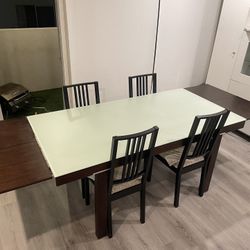 Glass top dining table and chairs with collapsable wings very good condition as is pick up or deliver. 