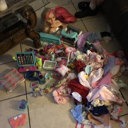 a whole bunch of baby clothes and american girl doll and barbie accessories
