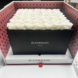 Elegant black box filled with vibrant red roses. 