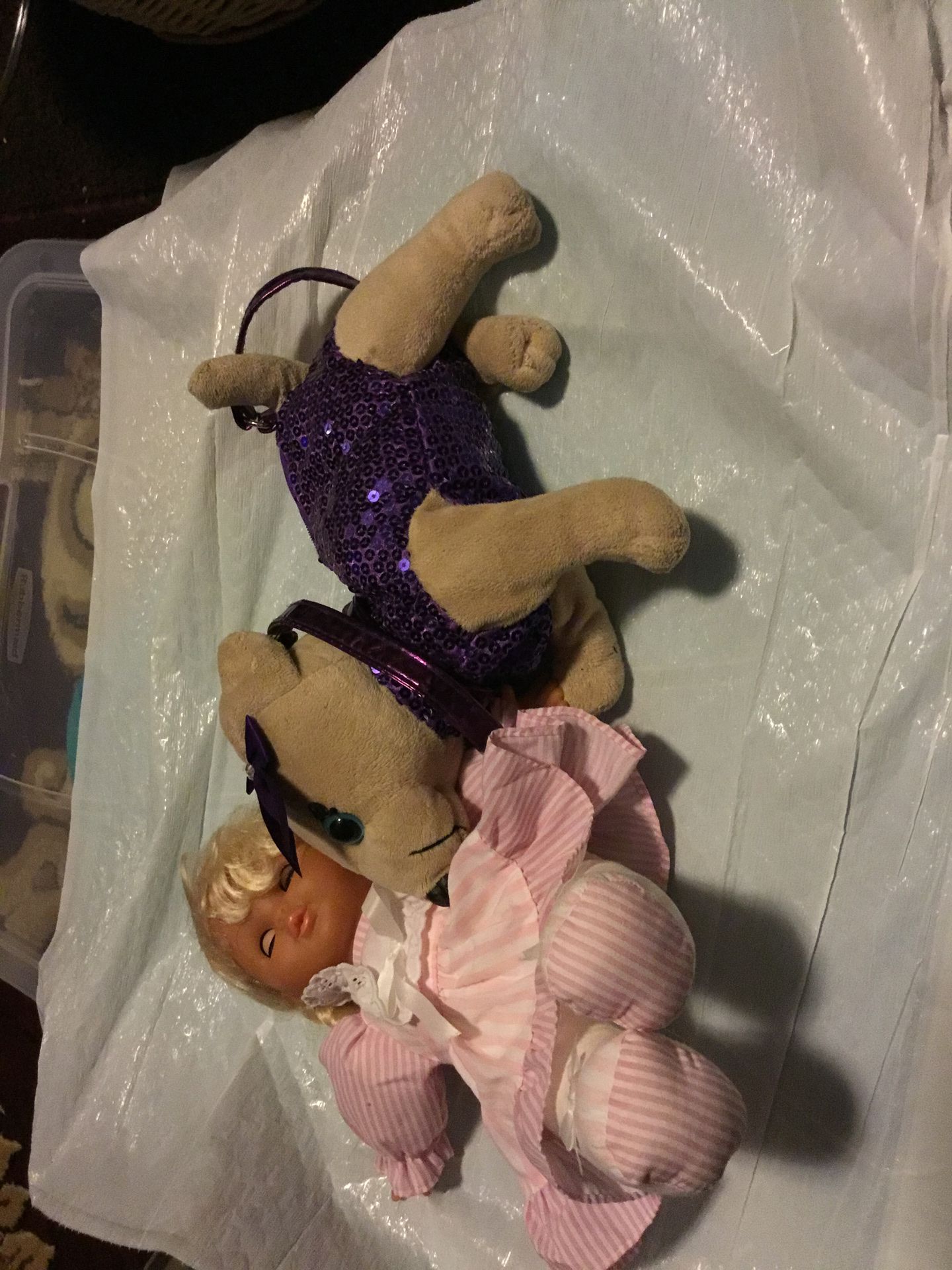 A beautiful doll with a lovely purse dog color purple it have a zipper on the purse