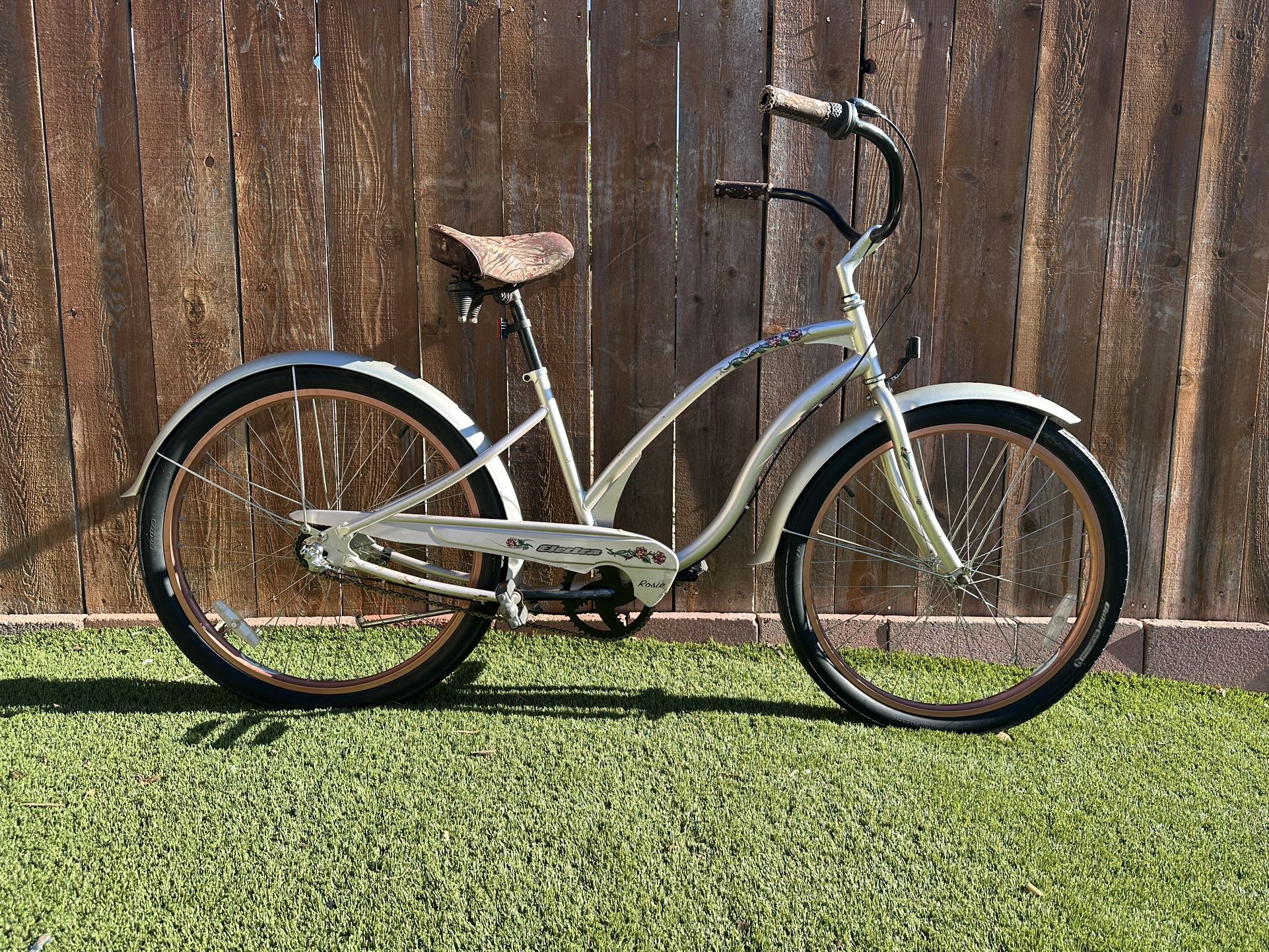 XMas Special. Electra Rosie model 26 inch women’s beach cruiser.  Pearl Silver with Bronze rims.  Three speed internal hub with coaster brake.  