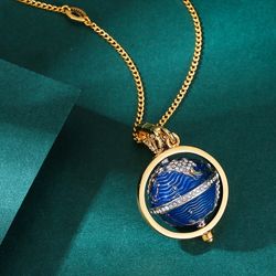 This stylish blue enamel globe crown pendant features a movable planet design and is perfect as a handbag charm for women