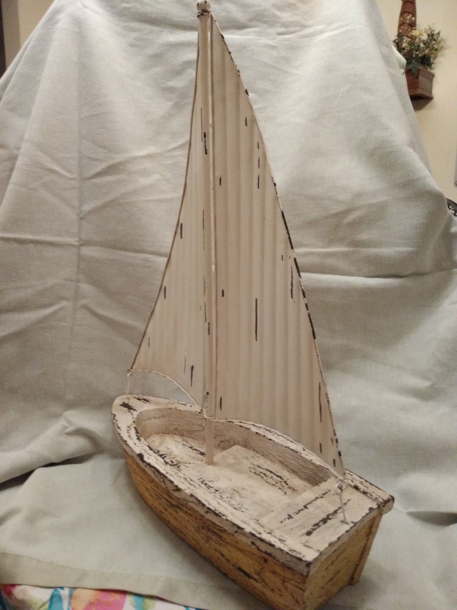 Sailboat featuring a metal rustic-looking sail