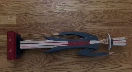 Americana Wooden Uncle Sam on a Square Pedestal. Handcrafted by Joe Langley. 23 inches tall by 5 inches wide. Base is 3.5 by 3.5 inches.