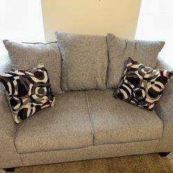 Gray Loveseat with Patterned Cushions