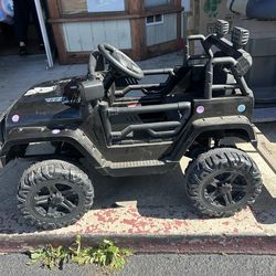 Ride-on electric jeep toy for children, similar to models from brands like Joyracer or Best Choice Products