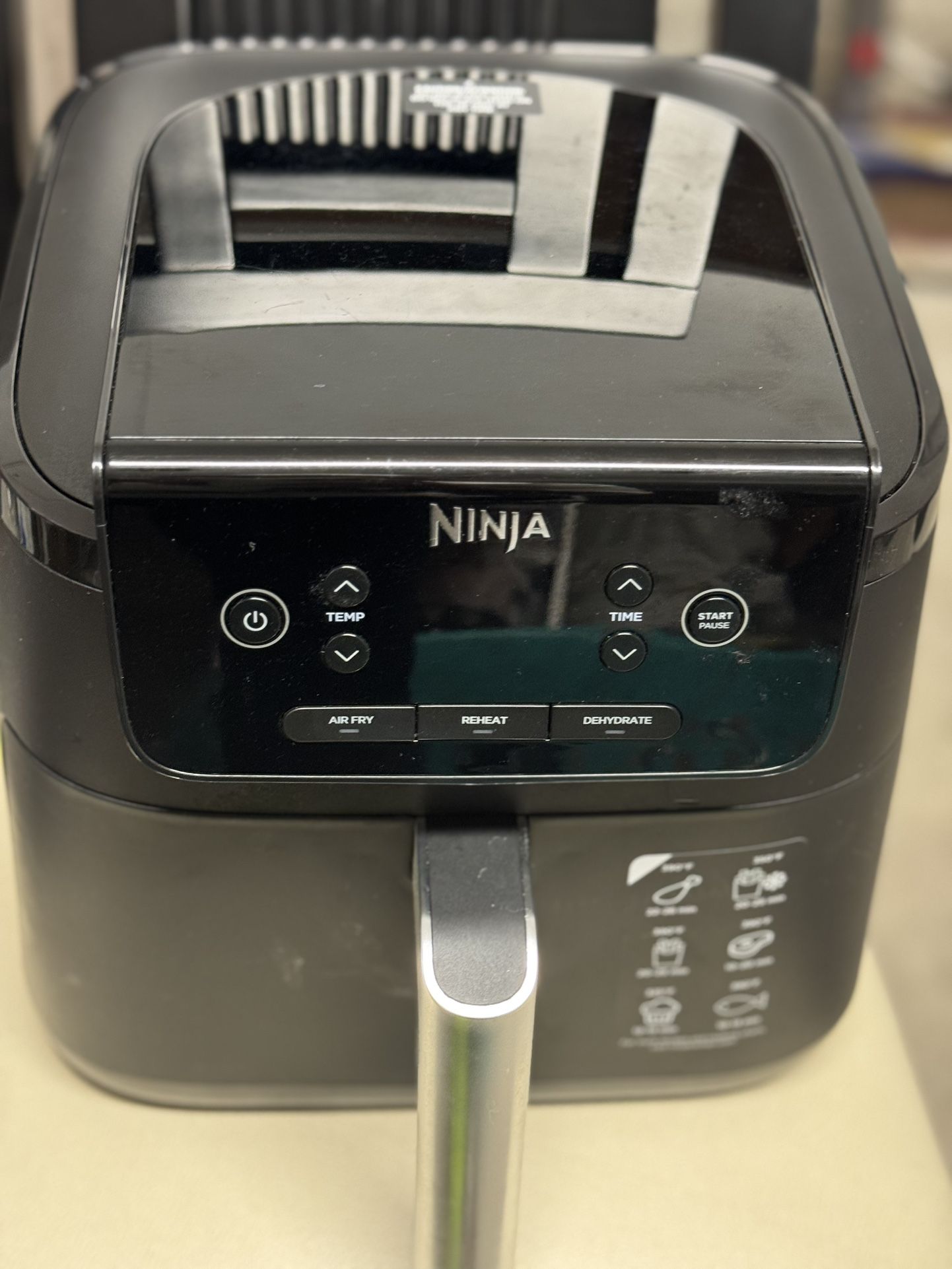 Ninja air fryer with multiple functions including air fry, reheat, and dehydrate.