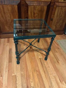 vintage wrought iron side table with a glass top and a green verdigris patina finish