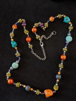 $8. Tropical necklace with orange stones, turquoise colored stones and other colored beads. 36 inches adjustable to 39 inches.