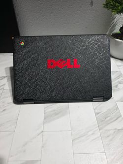 Black Dell Chromebook 5190 2-in-1 touchscreen convertible with a textured lid and visible scratching across the surface. Chrome OS logo on the top cor