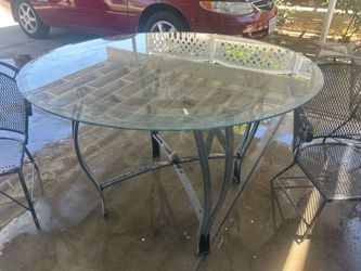 Glass table with three chairs