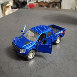 Die Cast Metal Blue 2011 Ford F-150 SVT Raptor Toy Truck, Jada Toys 1/32 Scale, "Raptor" Graphics, Openable Doors &Pull-Back Action 5"L X 2"W X 1.75"H
