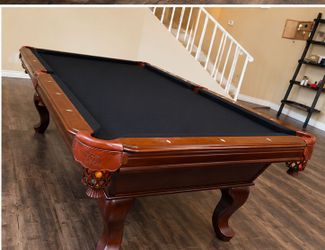 8-foot slate pool table, furniture-style cherry finish, leather shield pockets, basket drop pockets. Manufacturer unknown.