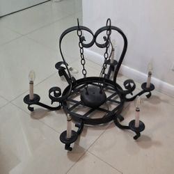 Round wrought iron chandelier in Gothic style with 6 lights. Heavy. Measures 28 inches wide. AS IS