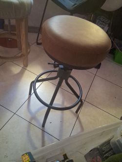 Industrial-Style Adjustable Height Swivel Bar Stool

This heavy-duty industrial-style bar stool features a thick, round, brown cushioned seat with a v