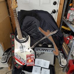 electric guitar bundle with amp, strap, stand, and long wire