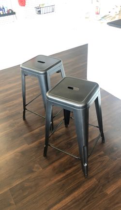 Two steel gray metal stools