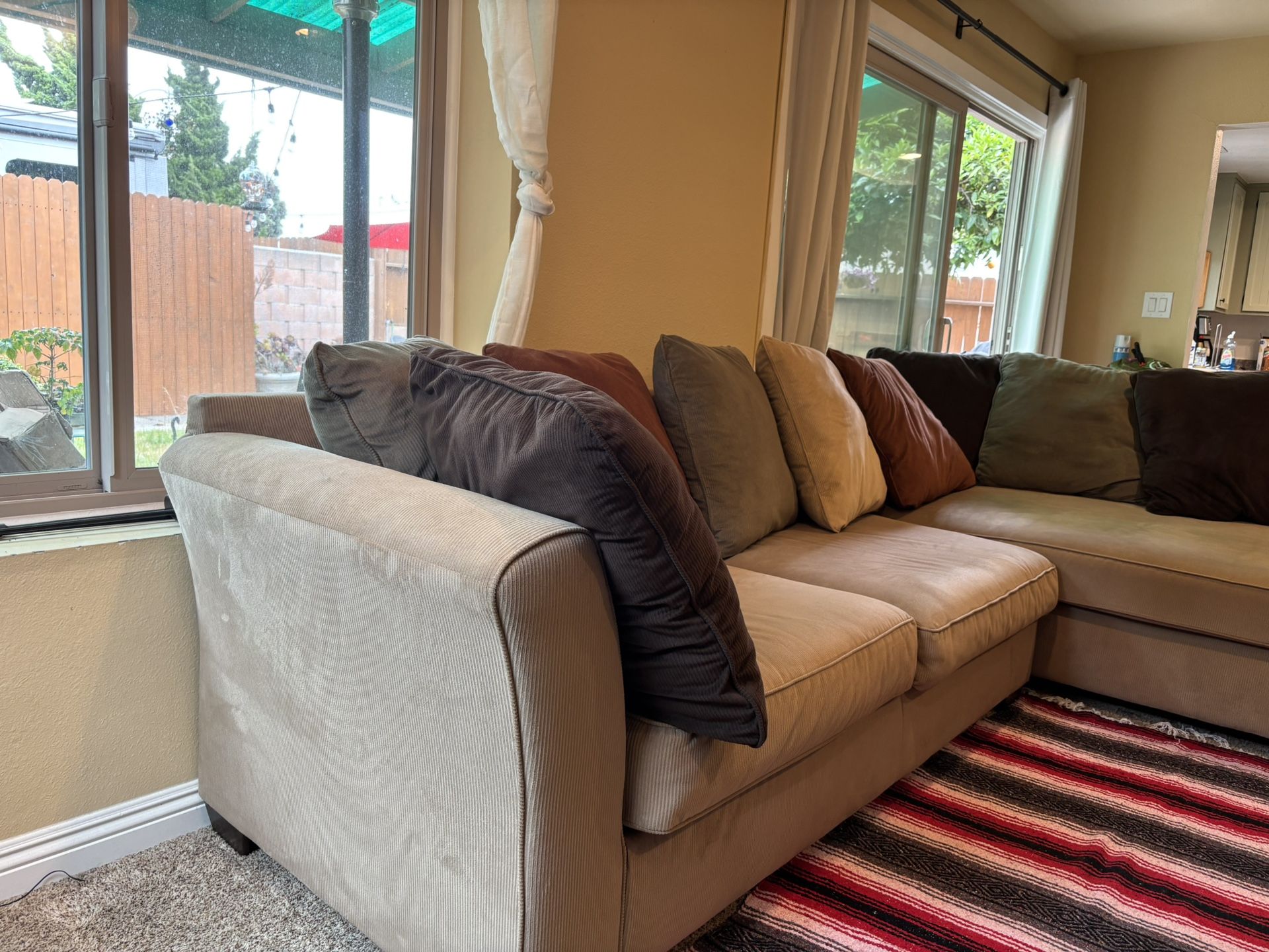Tan 3 piece sectional L shape with large circle spinning seat