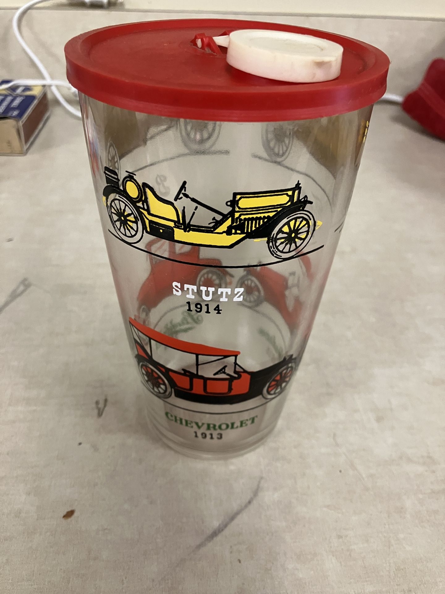 vintage Hazel Atlas glass cocktail shaker featuring antique car designs