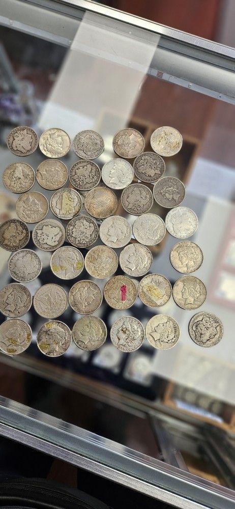 Morgans & Peace silver dollars Under Melt