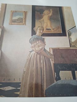 Young Woman Standing At Virginal by Johannes Vermeer