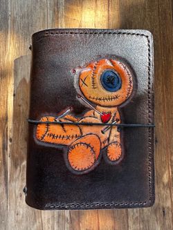 Pocket trifold travelers notebook with hand tooled and painted voodoo doll