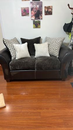 2 love seats . Dark brown with 5 pillows for each sofa.