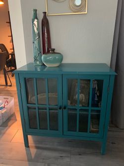 Teal blue cabinet and white tall glass cabinet