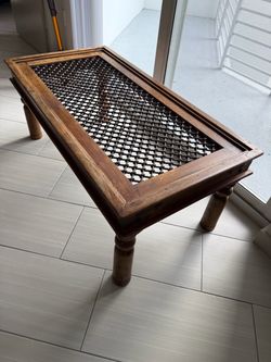traditional carved wooden coffee table with a lattice-style top