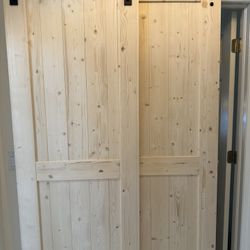 Two 28 inch solid wood barnyard doors. Holes for hardware have been pre-drilled. Hardware NOT included.