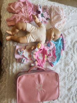 Bitty Baby and her suitcase and various clothes