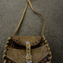 Tiny little tooled leather purse. Gross body or shoulder bag. Tan leather with rose floral design. Approx 4.5” x 4”  Vintage 70s 90s buckle hand made