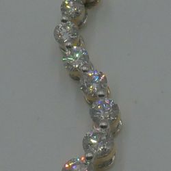 14kt yellow gold pendant “journey “ with round and baguette diamonds (3 carat approximately) super Mint. 8 round diamonds - 0.40;0.33;0.27; 0:23; 0.19