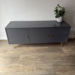 MODISH console - media center - three cabinet doors - gold hardware - storage - delivery available