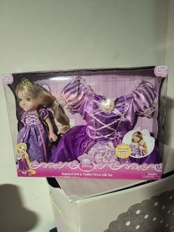Disney Princess Rapunzel gift set includes a doll wearing a signature purple dress and a matching toddler-sized dress for play.