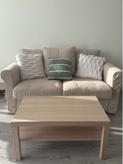 Beige Couch with pillows and coffee table