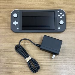 NINTENDO SWITCH LITE WITH CHARGER .