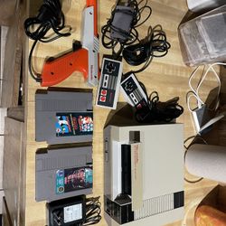 original 1985 nintindo with hookups , 2 controllers , 2 games, gun for duct hunt , etc works  