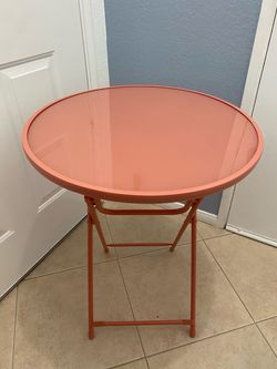 Round Metal Folding Outdoor Bistro Table In A Vibrant Coral Or Flamingo Pink Shade.