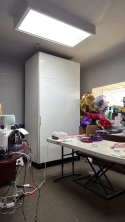 Very large cabinet with white board on the front