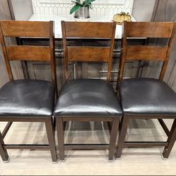 3-piece set of 24-inch solid wood barstools with leather seats, in good condition and very comfortable.
