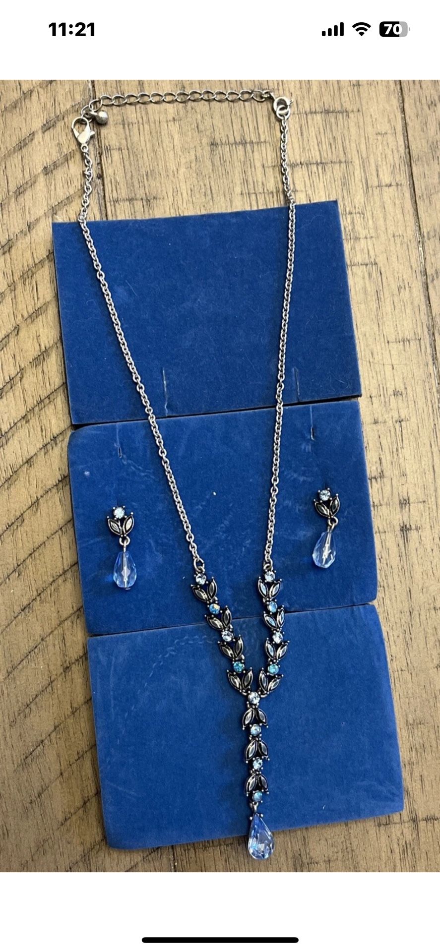 Silver toned necklace and earring set with blue stones.